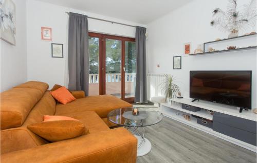 a living room with a couch and a flat screen tv at Lovely Apartment In Jesenice With Wifi in Jesenice
