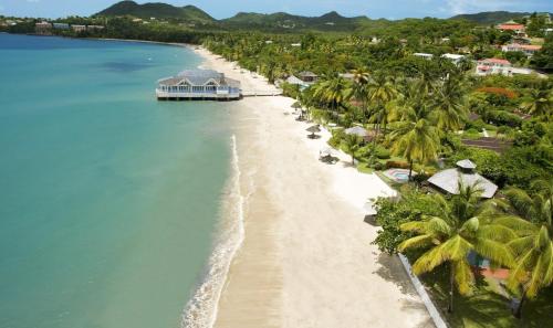 an aerial view of a beach with palm trees at Beachwalk Becune in Cap Estate