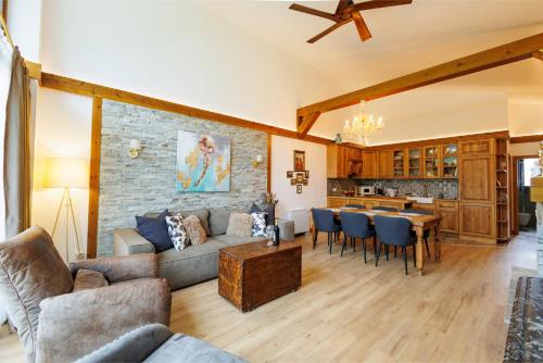 a living room with a couch and a table at Villa Eliyas with Jacuzzi near the Pirin Golf Resort in Razlog