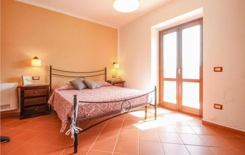 a bedroom with a bed and a large window at Lovely Home In Rutino With Kitchen in Rutino