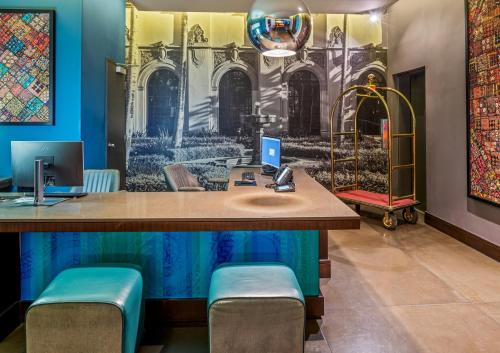 an office with a desk with a computer on it at SIRTAJ – Beverly Hills in Los Angeles