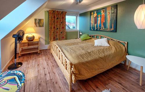 a bedroom with a bed and a table and a window at Beautiful Home In Höganäs With Wifi in Höganäs