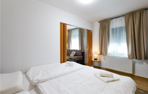 a hotel room with two white beds and a chair at Stunning Home In Ivanska in Ivanska