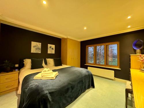 a bedroom with a bed with a towel on it at Stud House in Private Country Estate near Bruton in Gillingham
