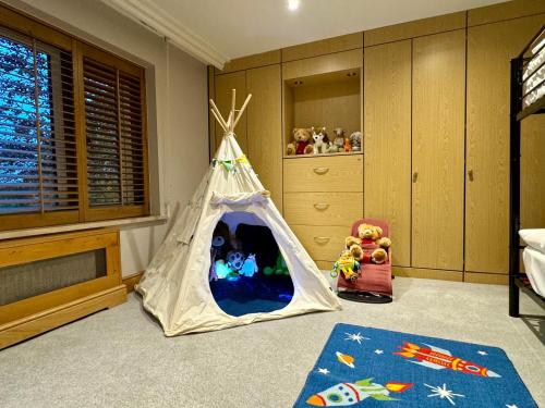 a childs bedroom with a teepee tent with toys in it at Stud House in Private Country Estate near Bruton in Gillingham
