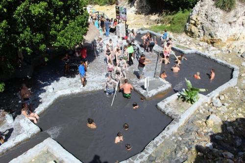 a group of people in a pool of water at Beachwalk Becune in Cap Estate