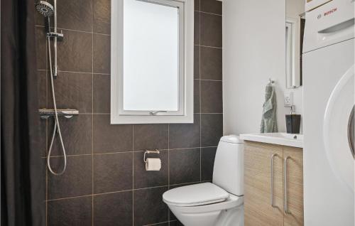 a bathroom with a toilet and a shower at Nice Home In Thyholm With Wifi in Thyholm