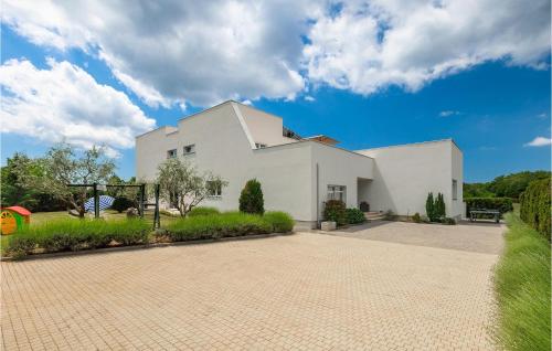 a white house with a driveway at Villa Kate in Žminj
