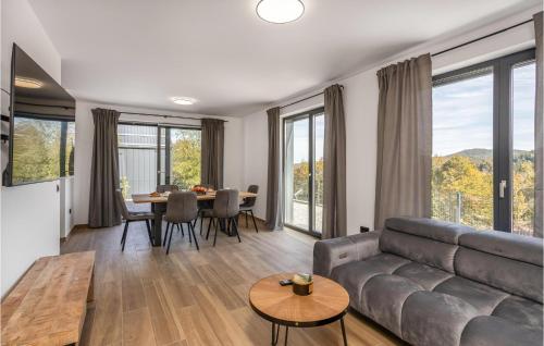 a living room with a couch and a table at Awesome Home In Stari Laz With Kitchen in Stari Laz