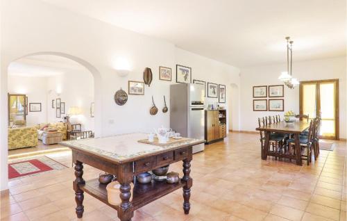 a kitchen and living room with a table and a refrigerator at Poggioalvento in Lazzeretto