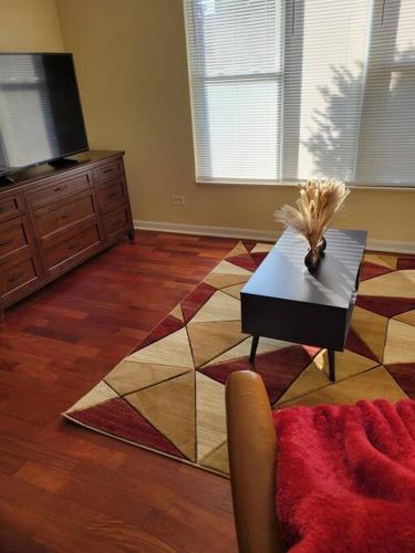 a living room with a coffee table and a tv at Charming 3BD 2BTH Apartment in Chicago