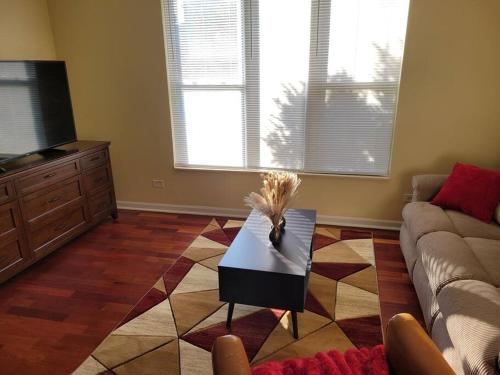 a living room with a couch and a table at Charming 3BD 2BTH Apartment in Chicago
