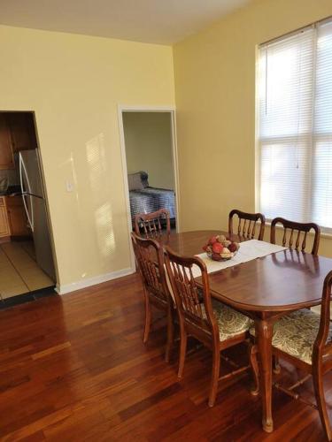 a dining room with a wooden table and chairs at Charming 3BD 2BTH Apartment in Chicago