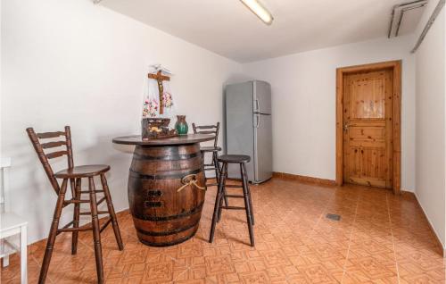 a kitchen with a wine barrel and a refrigerator at Awesome Home In Dragovanscak With Sauna in Slavetić