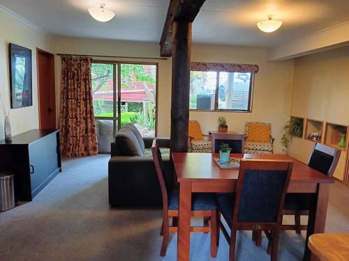 a living room with a table and a couch at Tahunanui holiday apartment in Nelson
