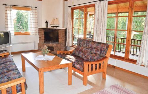 a living room with a couch and a coffee table at Cozy Home In Gislaved With Lake View in Våthult