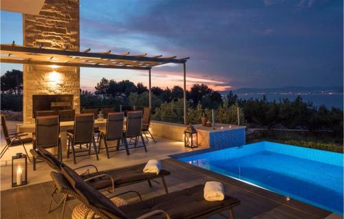 a patio with a pool and a table and chairs at Villa Elegant in Splitska