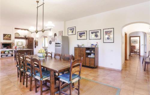 a kitchen and dining room with a wooden table and chairs at Poggioalvento in Lazzeretto
