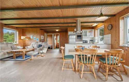 a kitchen and living room with a table and chairs at 3 Bedroom Beautiful Home In Spøttrup in Spottrup