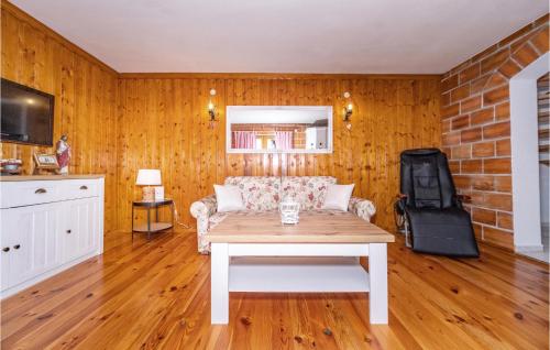 a living room with a couch and a table at Awesome Home In Dragovanscak With Sauna in Slavetić