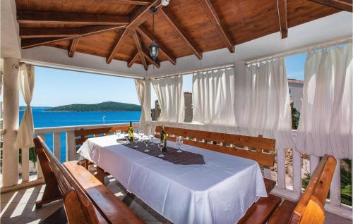 a dining room with a table and views of the ocean at Holiday Home Bok in Zaglavice