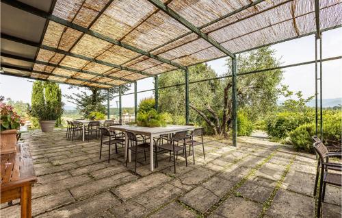 an outdoor patio with tables and chairs and windows at Awesome Apartment In Lazzeretto in Lazzeretto