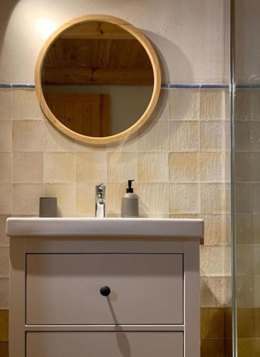 a bathroom with a sink and a mirror at La Llobatera Casa Rural in Les Coves de Vinroma