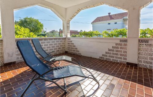 a blue chair sitting on a porch at Beautiful Apartment In Pinezici in Pinezici