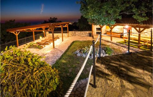a pavilion with a picnic table in a park at night at Lovely Home In Podstrana in Podstrana