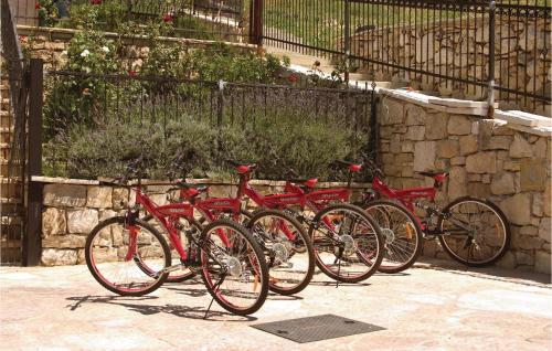 a row of red bikes parked next to a fence at Lovely Home In Podstrana in Podstrana