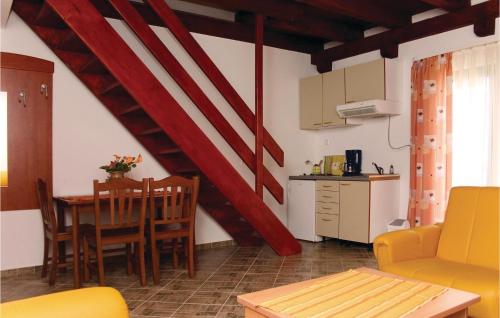 a kitchen and dining room with a table and chairs at Lovely Home In Podstrana in Podstrana