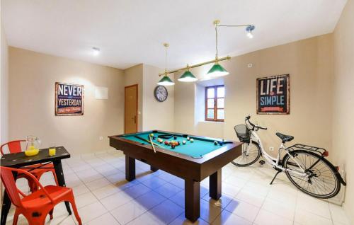 a room with a pool table and a bike in it at Villa Danica in Sukošan