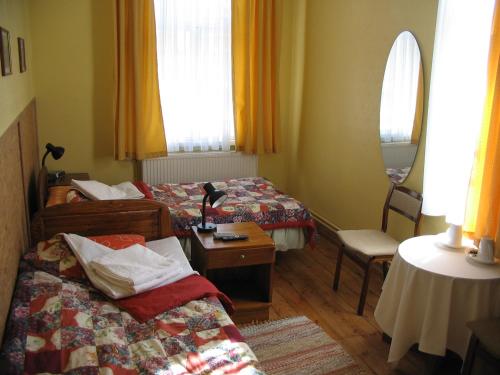 a hotel room with two beds and a table at Kastani Home Accommodation in Tartu