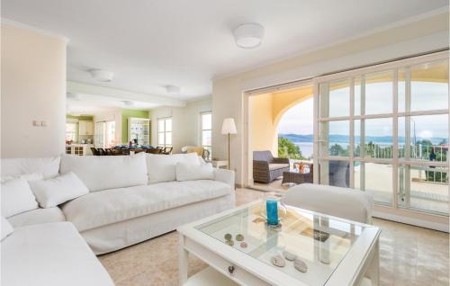 a living room with a white couch and a glass table at Awesome Home In Lovran With Sauna in Lovran