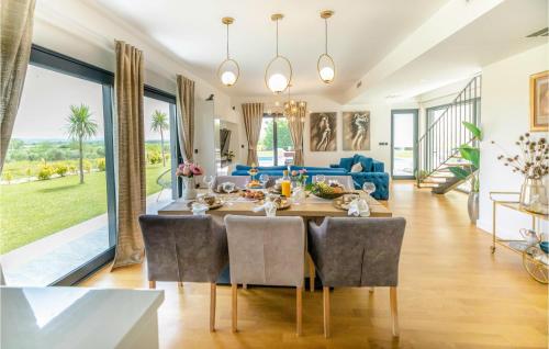 a dining room and living room with a table and chairs at Villa Lux in Donji Zemunik