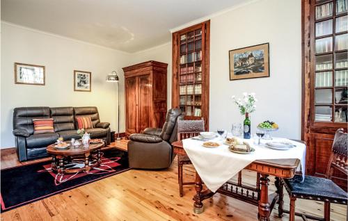a living room with a table and a couch at Les 3 Oies in Sarlat-la-Canéda