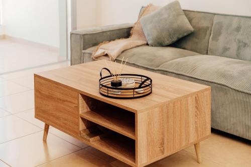 a wooden coffee table in a living room with a couch at Spitaki 2 BDR Apartment with Pool and Close Proximity to Beach in Paralimni