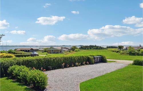 a gravel path through a garden with bushes at Holiday Home Limfjordsvangen Snedsted X in Skyum
