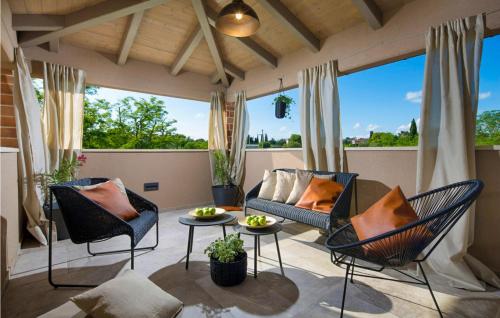 a living room with chairs and a couch on a balcony at Villa Astarea in Vodnjan