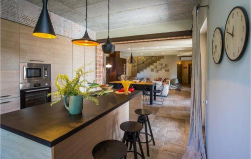 a kitchen and dining room with a large clock on the wall at Villa Astarea in Vodnjan