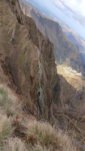 a view of a rocky mountain with a waterfall at Appartement chaleureux et cosy in Le Mont-Dore