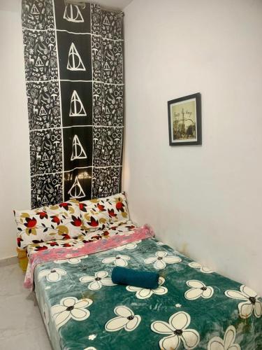 a bedroom with a bed with a green and white blanket at Matinxs Home in Abu Dhabi