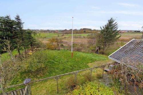 a view of a field with a house and a fence at Cozy Holiday Home In Thisted in Thisted