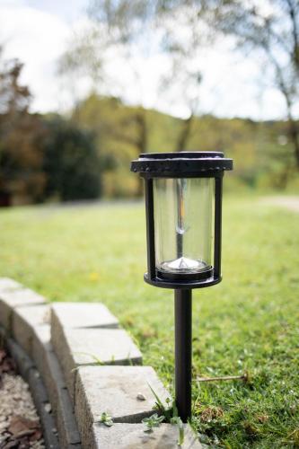 a black light in the grass near a field at Stellar Glamping Auckland in Auckland