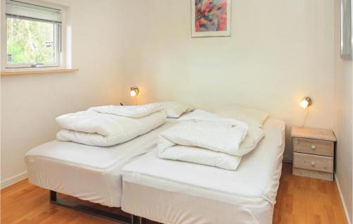 two stacks of white towels sitting on top of a bed at Holiday Home Koldingvej in Almind
