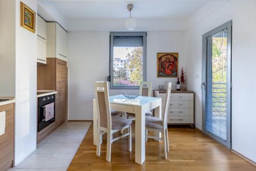a kitchen with a dining room table and chairs at Skopje&Joy Central Flat in Skopje