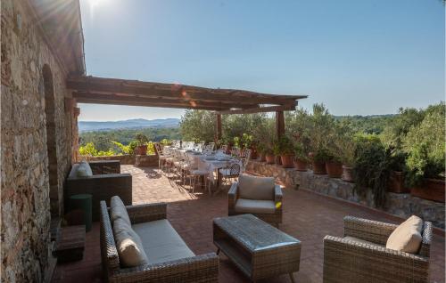 a patio with a table and chairs and a view at Tenuta San Crescenzio in Magliano in Toscana