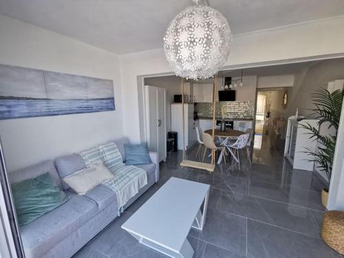 un salon avec un canapé et une table dans l'établissement SUPERBE APT VUE MER- 6 pers- HYPER CENTRE, au Grau-du-Roi