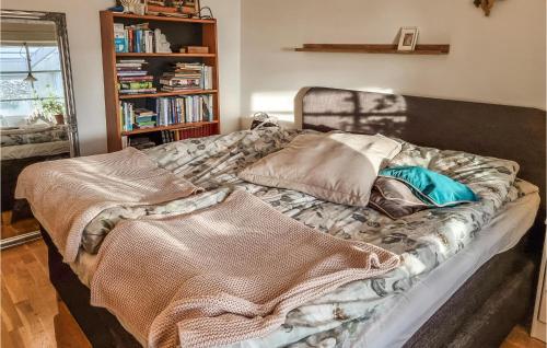 a bed with pillows on it in a room at Amazing Home In Rönnäng With Sauna in Rönnäng