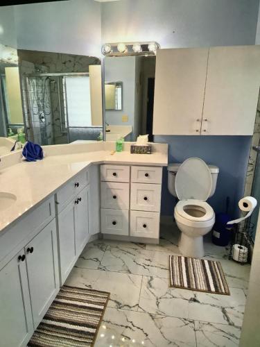 a bathroom with a toilet and a sink and a mirror at Mozzy-Love Room in Orlando